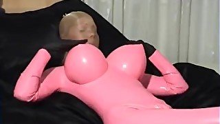 Girl In Pink Latex Catsuit With Big Boobs And Shiny Encasement Pantyhose