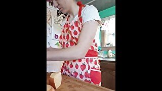 Young MILF cooks pasta sauce in a little outfit