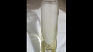 Relaxing piss into glass bottle