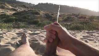 Masturbating on nudist beach. Slowmotion cumshot