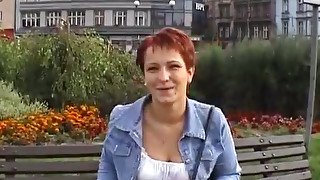 Mature euro redhead short-haired woman gives an interview