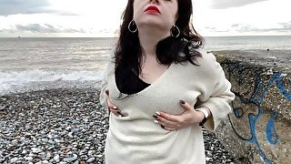 Hot Mistress Lara is playing with her big natural tits at the beach