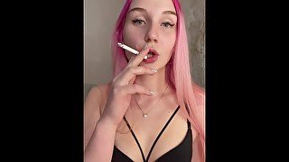 Nude girl with pink hair smoking a cigarette