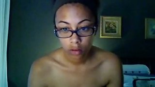 Ebony girl in glasses exposes her body for the webcam