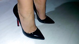 Businesswoman Showing Her Feet And Legs In Expensive Pair Of Black Shoes