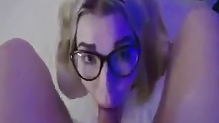 Blonde girl with glasses sucks a tattooed guy and swallows