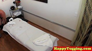 Asian masseuse jerking and riding on client