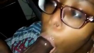 Nerdy ebony girl works her sexy lips on a thick black cock