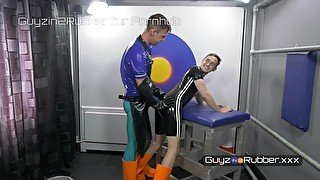 Two guys in tight shiny rubber & orange boots arse fingering, jerking each other, dildos, rimming