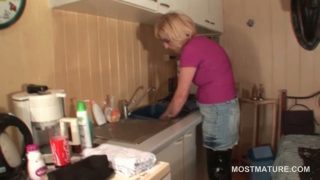 Mature housekeeper teasing her hot snatch in the kitchen