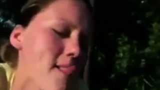 She sucks dick outdoors and eats cum out of a condom