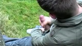 Cute twink Adam Jamieson jerks off his thick cock outdoor