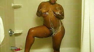 Awesome big bottomed chocolate nympho takes a shower and masturbates