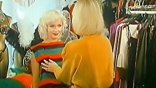 Two playful and joyful blonde ladies eat each other in the dressing room