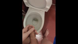 The guy pisses in the toilet for a long time