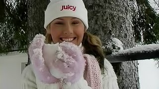 An adventurous hottie rubs snow against her shaved pussy