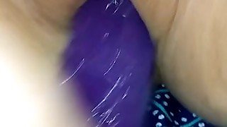 Masturbating with purple dildo