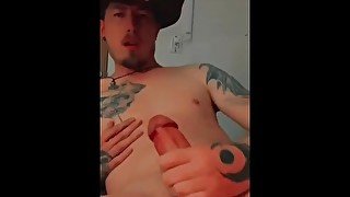 Tattooed cowboy jerks big cock until cum