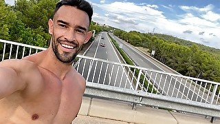 Fit guy gets naked next to a highway on a bridge. Very Risky!