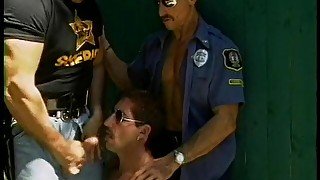 Two horny jacked gay cops and a hot perp get some sucking outside