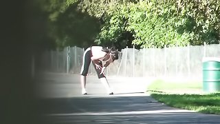 Curvy woman in workout gear is recorded while she stretches and runs in a public park.