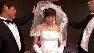 A Japanese bride wears her wedding gown while bouncing on a dick