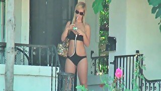 Chick walks in her swimsuit and smokes outdoors