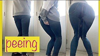 OL wearing jeans in front of a public toilet desperate to  pee