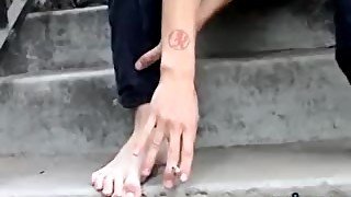 Young punk presents his sexy feet while smoking