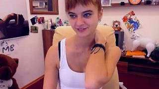 Skinny little redhead is on her webcam and does a slow stri