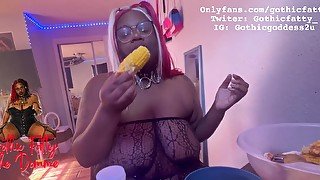 Ebony BBW stuffs her face while she is topless