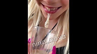 Sick girl is hocking and spitting loogies phlegm snot and mucus into the glass