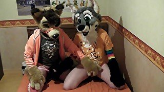 Two cute fursuiters giving helping hand to each others