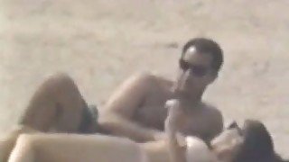 Hidden cam scene with a couple making love on a beach