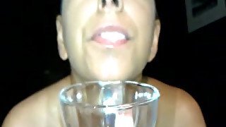 She spits all the cum deposit in the glass and savors it like juice