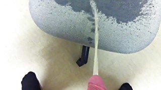 Naughty pissing all over an office chair at work