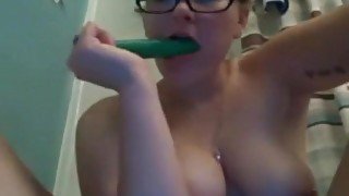 Woman transfers green dildo from ass to mouth