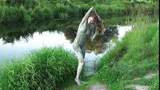 Playful teenager coats her skin with mud