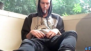 Homosexual thug takes a smoke outdoors and jacks off