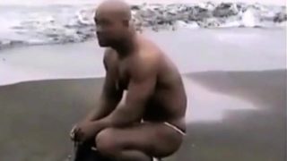 Asian bodybuilder barely covered at the beach