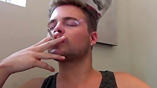 Hot guy smoking and masturbating furiously before cumming