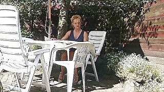 Blonde milf showing off her boobs outdoors