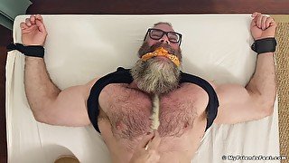 Muscular older dude tied up to a bed and licked by his best friend