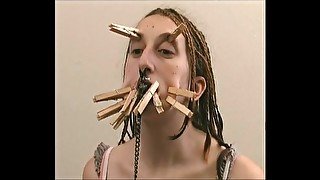 Both girl with clothes pins on her face