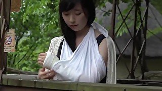 Japanese girl unwraps bandage from her injured ankle