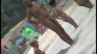 Voyeur view of fun in the water on a nudist beach