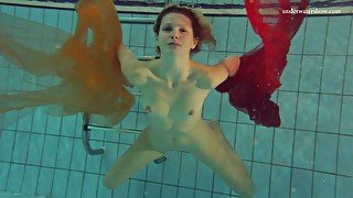 Pretty hot red head Nastya is stripping under the water