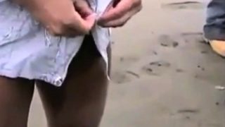 Asian bodybuilder barely covered at the beach