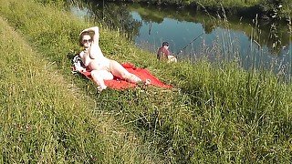 Nudist Beach. Public Nudity. Sexy Milf Without Panties And Bra Sunbathes Naked Is Not Shy About Fisherman. Naked In Public. Milf