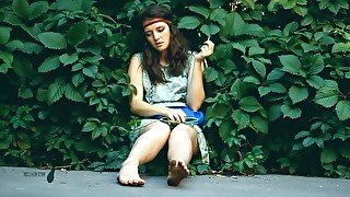 Adorable Brunette Hippy Gal Sits In Shrubs And Her Dirty Feet While Smoking